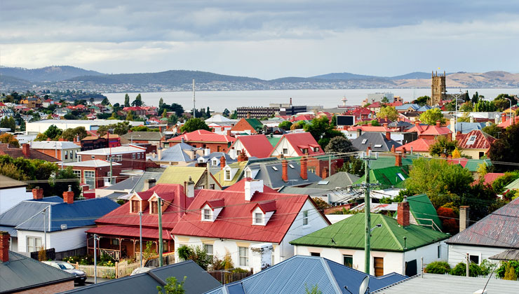 Colorful rooftops of yellow, red, green, and blue in the suburbs of Hobart, Australia.