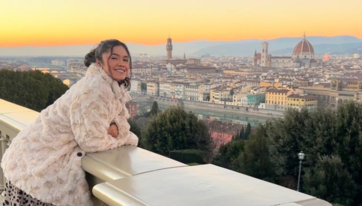 Student in Florence, Italy, at the Piazzale Michelangelo at sunset with the Duomo in the background.