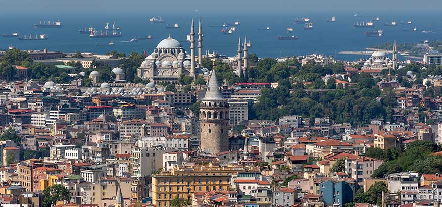 Aerial view of Galata Tower, Suleymaniye Mosque, and Marmara Sea on a sunny day in Istanbul, Turkey.