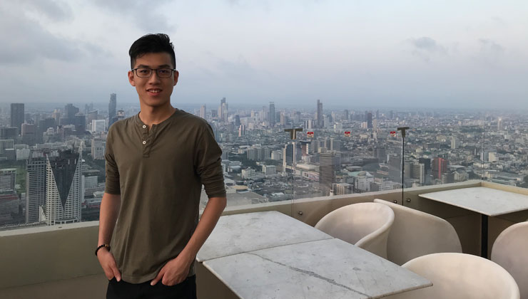 A student posing on a balcony in Bangkok Thailand. 