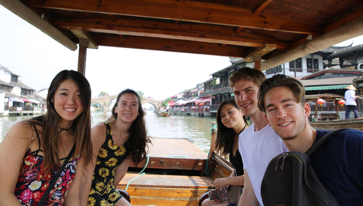 Students smiling on a boat ride in Beijing, China