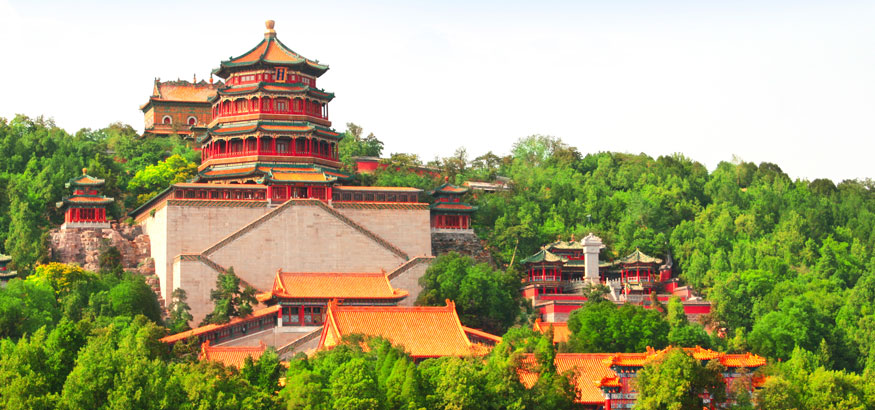 View of Beijing's Summer Palace with lush green trees around the buildings in Beijing China. 