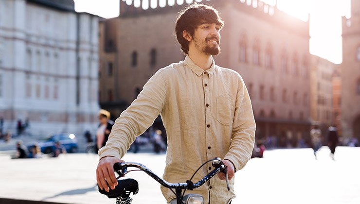 Student pushes a bike in Bologna, Italy. 