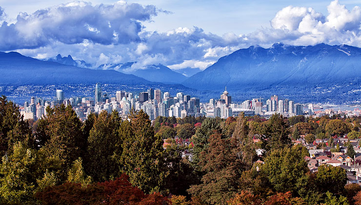 Shot of Vancouver skyline with mountains in the background taken from Queen Elizabeth Park in Canada.