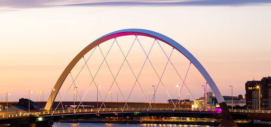 Sunrise reflects on The Clyde Arc over the Clyde River in Glasgow, Scotland