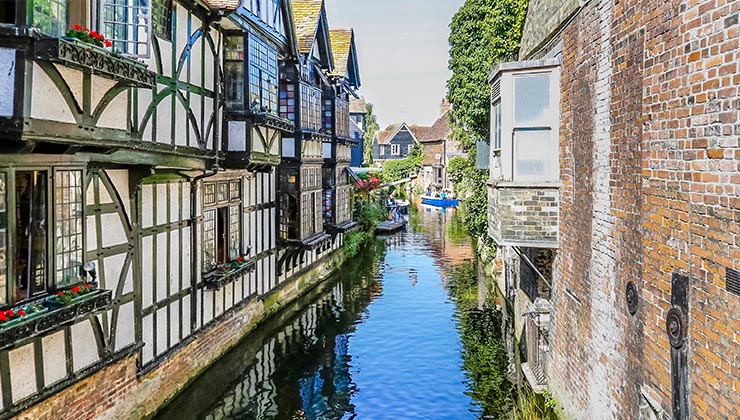 During summer, medieval buildings line a canal in Canterbury, UK-England.