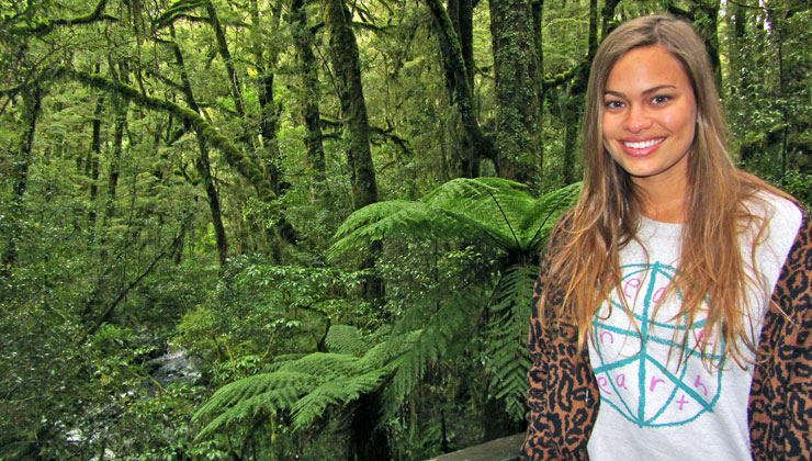 Student smiling on a hike in the rainforest in New Zealand. 