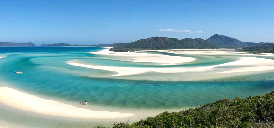 Whitsunday Island with bright blue water and white sand in Sydney, Australia. 