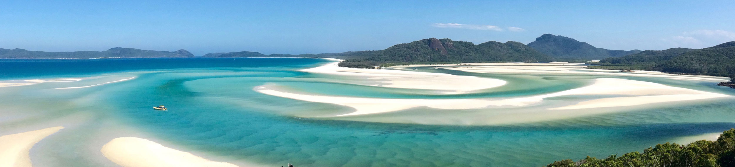 Whitsunday Island with bright blue water and white sand in Sydney, Australia. 