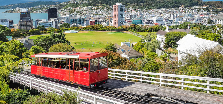 Red Cable car ascending hill overlooking Wellington, New Zealand