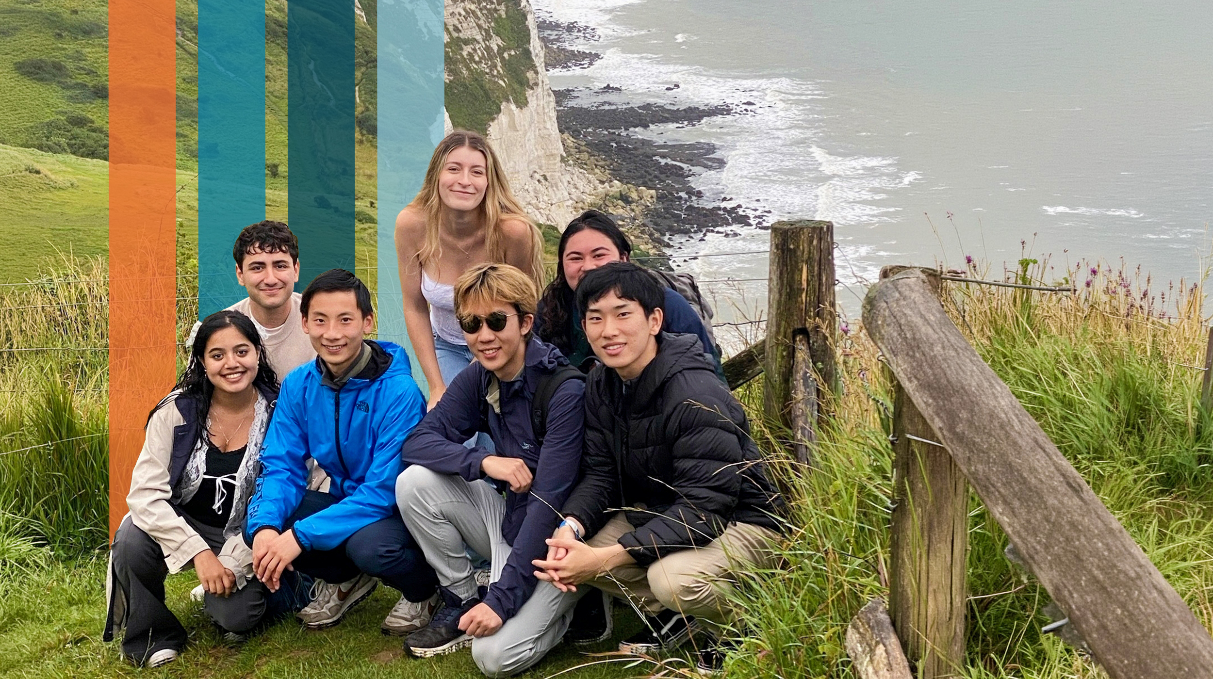 Group of students at a scenic view overlooking white chalk cliffs and ocean