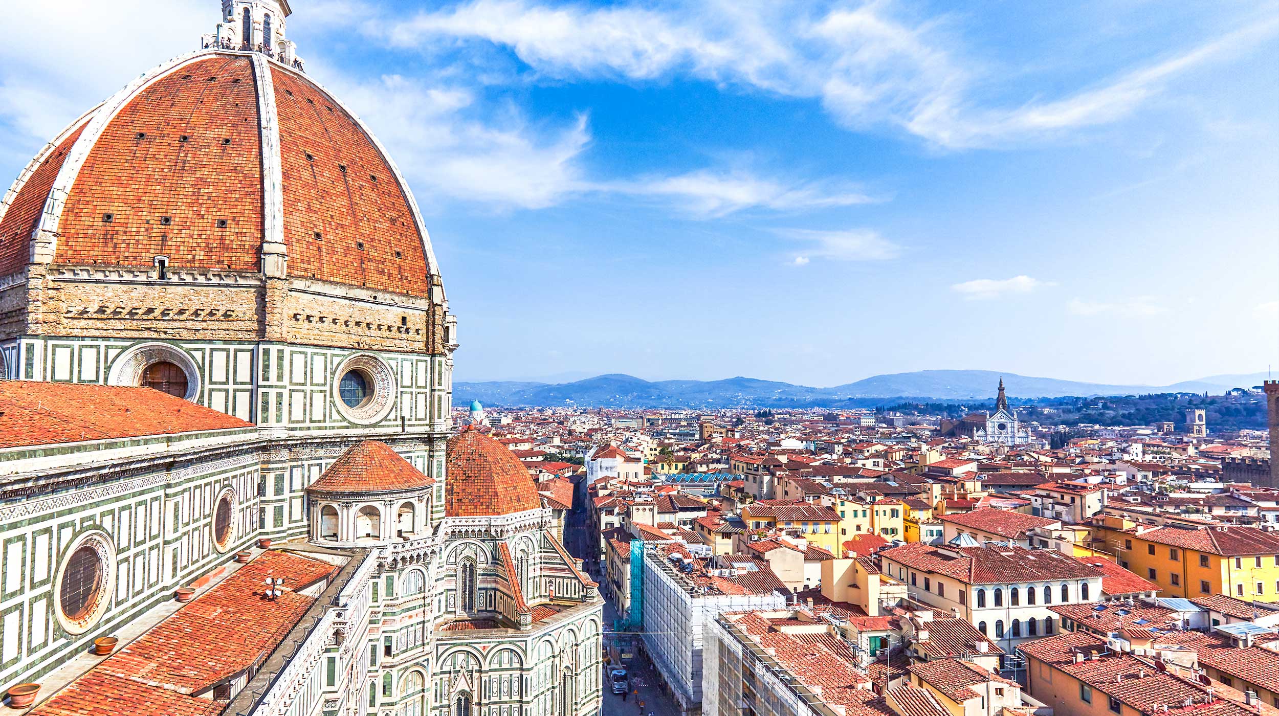 Skyline view of red tiled Duomo dome, and roofs of Florence, Italy.