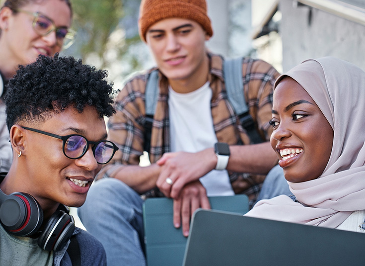 Students looking at a laptop screen
