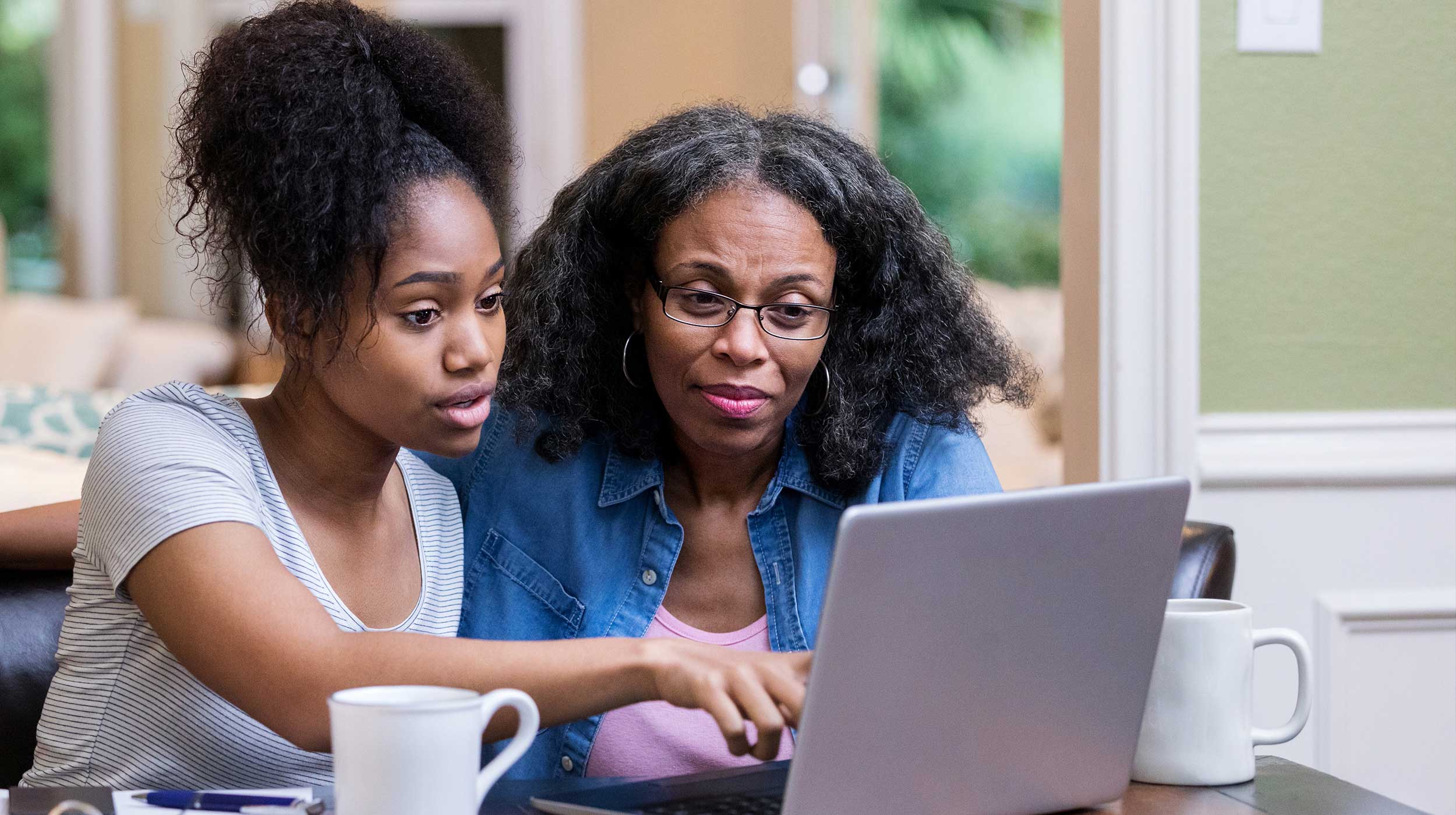 student and parent looking at a laptop