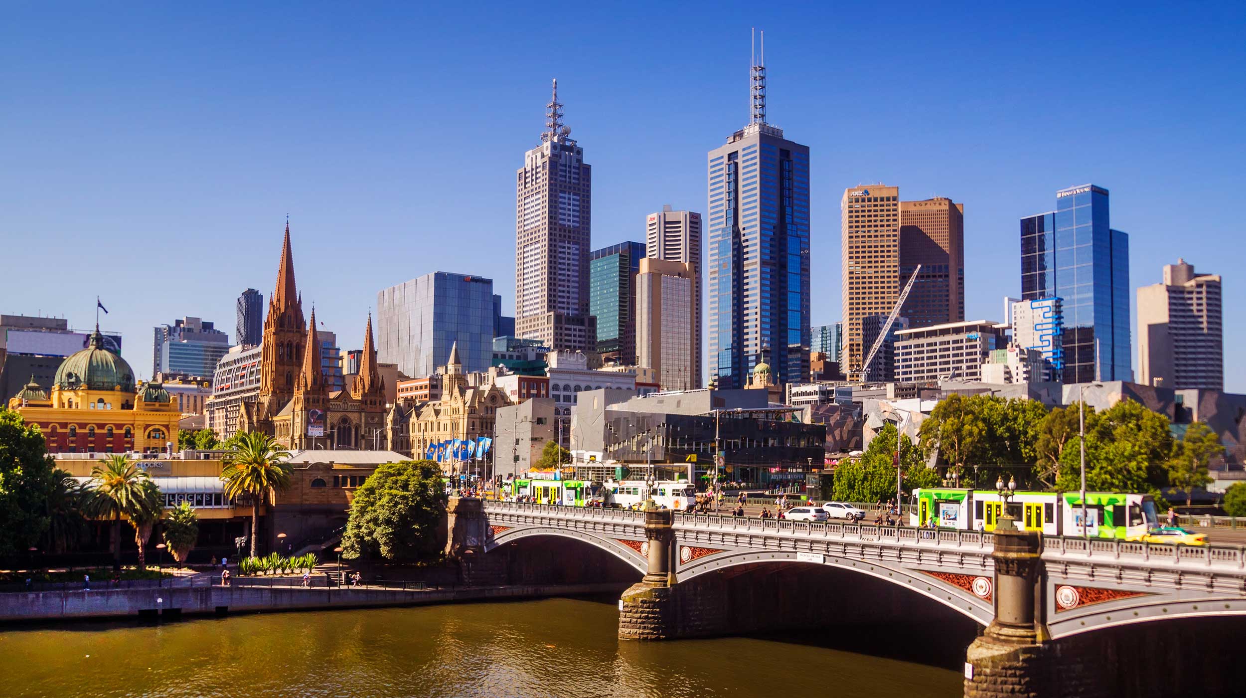 Prince bridge scenery city of Melbourne with streetcars, modern and traditional buildings.