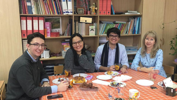 Four friends sit down for tea and treats in Yaroslavl, Russia.