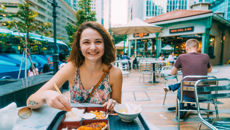Young woman dining on Japanese food in downtown Singapore.