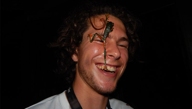 Student smiles with a Red-Eyed Tree Frog stuck to this forehead in Costa Rica.