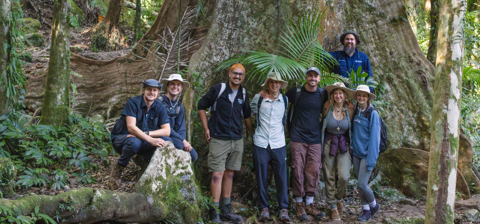 A group of students and professor pose for a photo in a forest in Costa Rica.