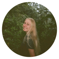 Eleanor Terner smiles for a photo in a foresty area. 