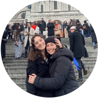 Catherine Parker and a friend pose in front a crowded set of steps.